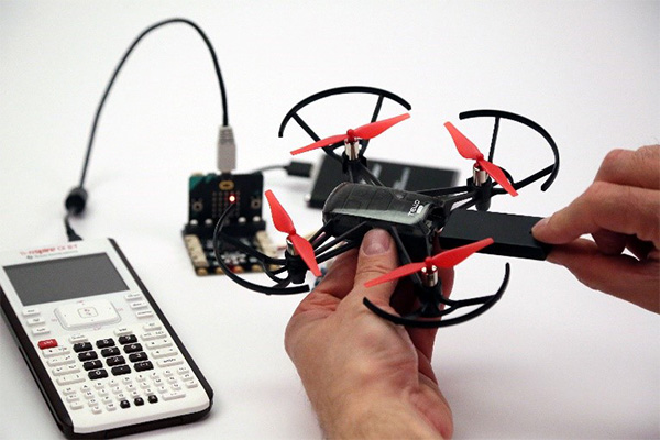 Picture of a hand contecting a drone using a TI graphing calculator